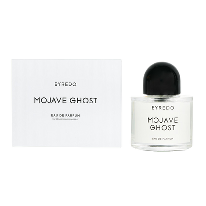 A bottle of Baccarats' "Mojave Ghost EDP for Men and Women." The cylindrical bottle with a transparent body showcases the label proudly displaying the product's name. The round black cap completes its sleek and minimalist appearance, embodying Mojave Ghost as your exotic floral signature scent.