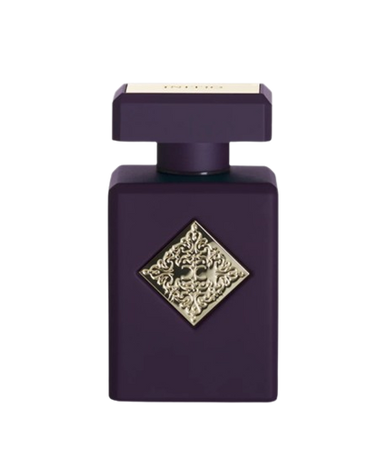 The INITIO SIDE EFFECT EDP 90ml by Baccarats is housed in a dark purple bottle with a square design, featuring a gold embossed decorative emblem at its center. The bottle is topped with a matching square, flat cap and exudes luxury, capturing the essence of rich vanilla and tobacco notes.