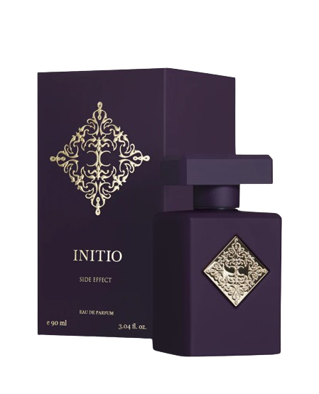 The INITIO SIDE EFFECT EDP 90ml by Baccarats is housed in a dark purple bottle with a square design, featuring a gold embossed decorative emblem at its center. The bottle is topped with a matching square, flat cap and exudes luxury, capturing the essence of rich vanilla and tobacco notes.