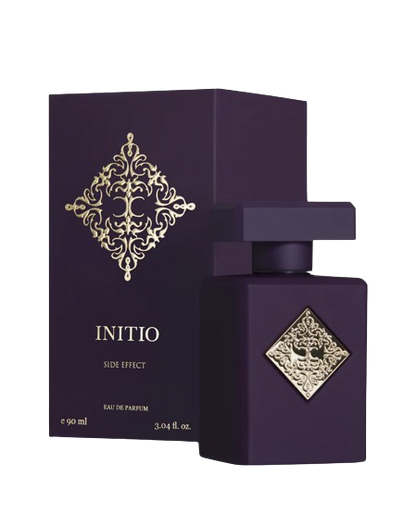 The INITIO SIDE EFFECT EDP 90ml by Baccarats is housed in a dark purple bottle with a square design, featuring a gold embossed decorative emblem at its center. The bottle is topped with a matching square, flat cap and exudes luxury, capturing the essence of rich vanilla and tobacco notes.