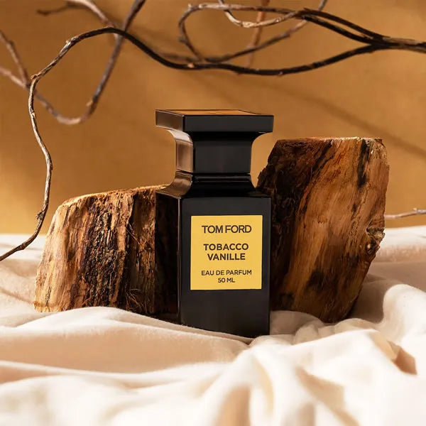 A 50 ml bottle of Baccarats Tom Ford Tobacco Vanille Eau de Parfum for Men and Women exudes an opulent fragrance reminiscent of a private gentleman's club. Its dark, sleek design and gold label elegantly showcase the distinguished scent.