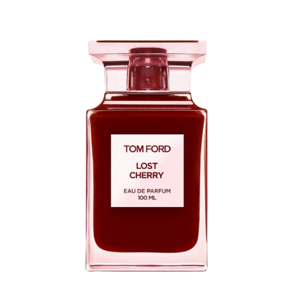 A rectangular, translucent pink bottle with a red liquid inside displays a front label that reads "TOM FORD LOST CHERRY EAU DE PARFUM 100 ML." Infused with the richness of black cherry, the bottle features a square-shaped, translucent pink cap. This unisex fragrance is offered by the brand Baccarats under the name Tom Ford Lost Cherry Eau De Parfum for Men and Women.