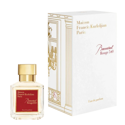 A transparent glass bottle of perfume with a gold cap, featuring "Baccarats Baccarat Rouge 540 Eau de Parfum for Men and Women" in gold and white text on a red background, embodies the essence of an amber floral fragrance.