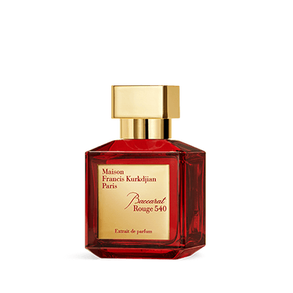 A bottle of Baccarats Baccarat Rouge 540 Extrait de Parfum for Men and Women. The red bottle, with a golden cap and gold label, elegantly showcases the brand name and fragrance details of this exquisite Amber Floral fragrance.