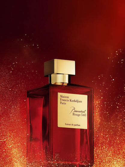 A bottle of Baccarats Baccarat Rouge 540 Extrait de Parfum for Men and Women. The red bottle, with a golden cap and gold label, elegantly showcases the brand name and fragrance details of this exquisite Amber Floral fragrance.