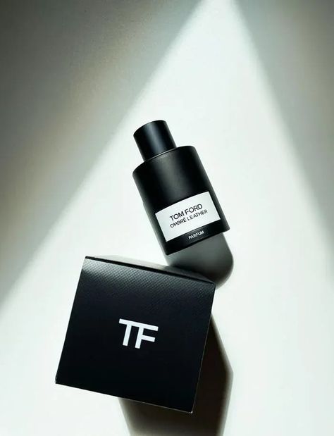 A sophisticated black bottle of Tom Ford Ombre Leather Parfum for Men and Women 100ml by Baccarats exudes elegance. Its minimalist design with a matte finish encases the scent of cedarwood, featuring a label with the brand name and fragrance title.