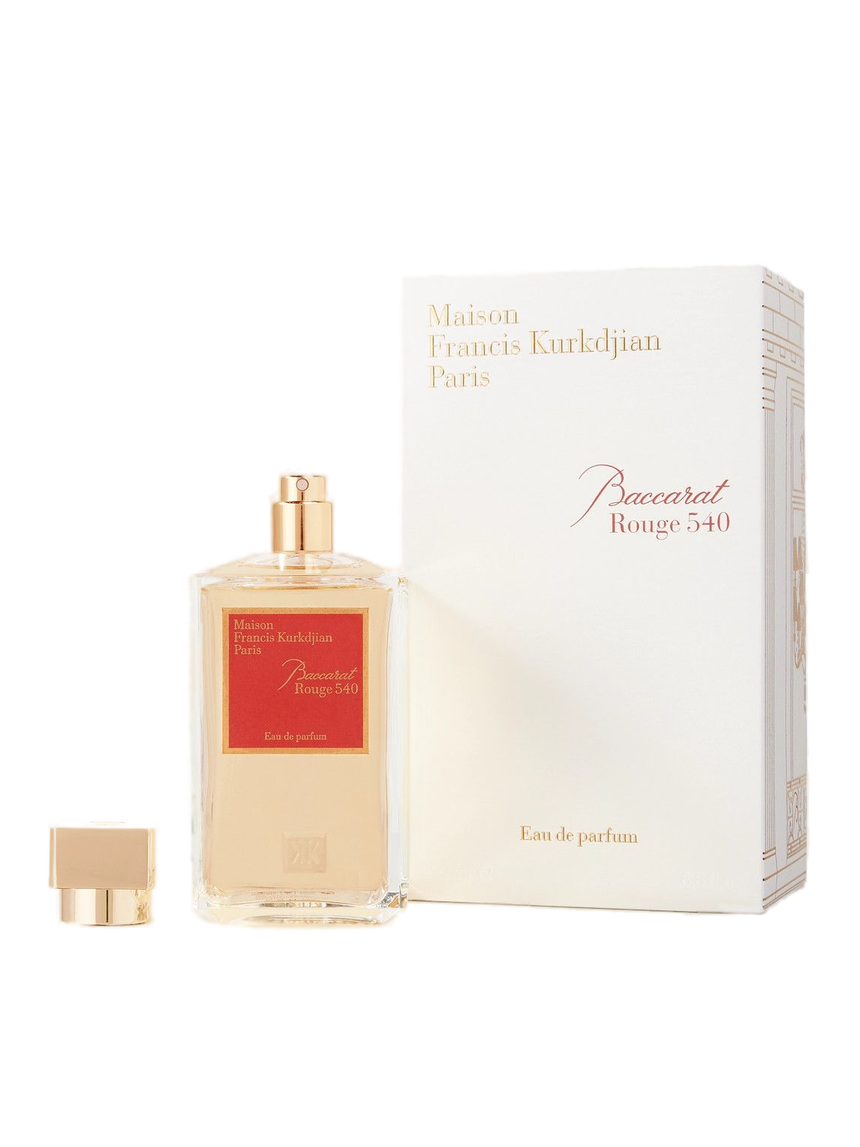 A transparent glass bottle of perfume with a gold cap, featuring "Baccarats Baccarat Rouge 540 Eau de Parfum for Men and Women" in gold and white text on a red background, embodies the essence of an amber floral fragrance.