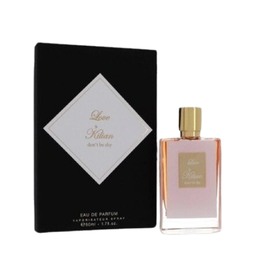 A rectangular glass bottle of By Kilian Love, Don't Be Shy perfume with a gradient pink hue, featuring a gold cap and a square gold label on the front, embossed with the text "Love by Kilian, don't be shy." Infused with delicate notes of Orange Blossom, this Baccarats fragrance captivates from the first spritz.