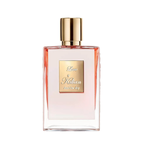 A rectangular glass bottle of By Kilian Love, Don't Be Shy perfume with a gradient pink hue, featuring a gold cap and a square gold label on the front, embossed with the text "Love by Kilian, don't be shy." Infused with delicate notes of Orange Blossom, this Baccarats fragrance captivates from the first spritz.