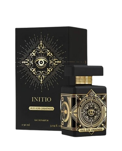 A 90ml bottle of Baccarats' Initio Oud for Greatness EDP. The black bottle, adorned with elaborate gold detailing, features an intricate design highlighted by a prominent eye motif on the front. Infused with rich and captivating notes of patchouli and oud wood, the fragrance exemplifies luxury. The cap is black with elegant gold accents.