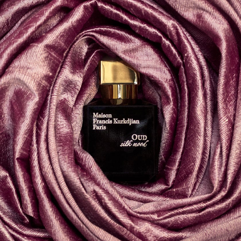 A sleek, rectangular dark blue perfume bottle with a gold cap, labeled "Baccarats OUD Silk Mood Eau de Parfum 70ml" in gold text. This minimalist eau de parfum boasts an elegant design that embodies sophistication.